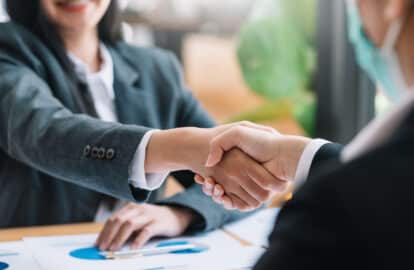 image of businesswoman shaking hands to congratulate success.