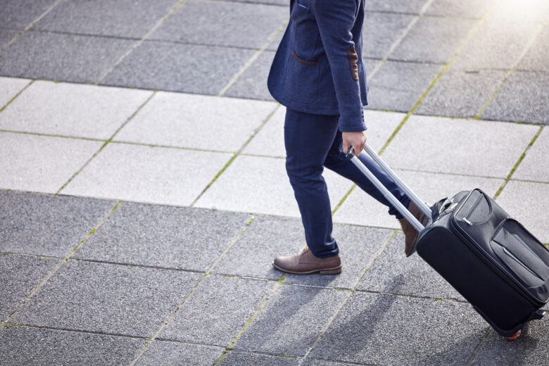 shot of a businessman making his way to the airport with his suitcase.
