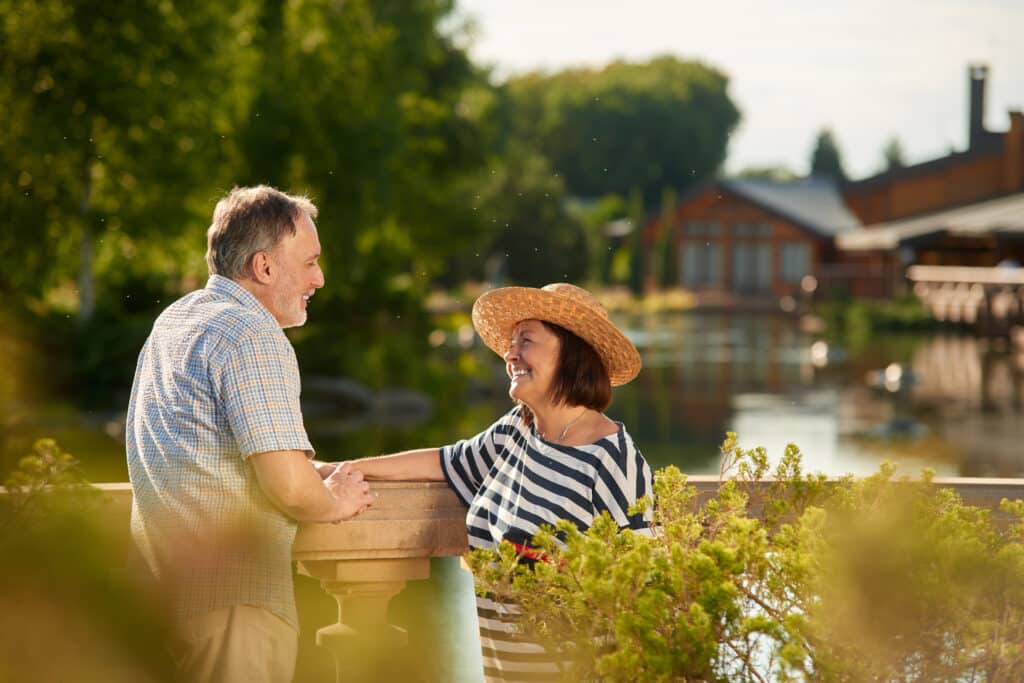 smiling loving mature couple look at each other.