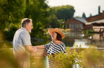smiling loving mature couple look at each other.