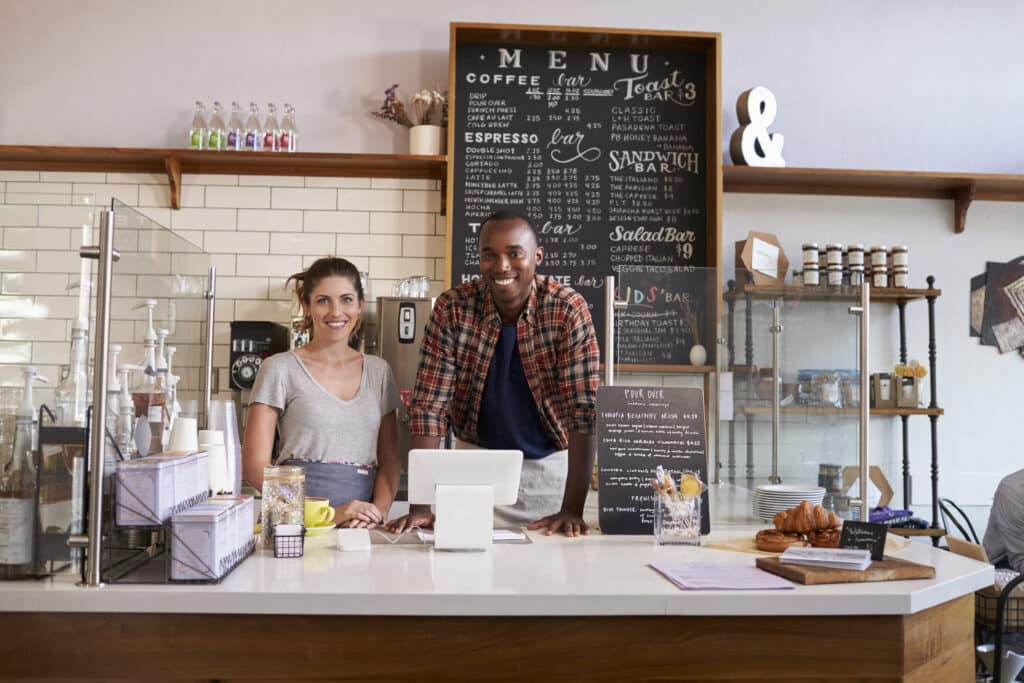 mixed race couple waiting behind counter at a coffee shop