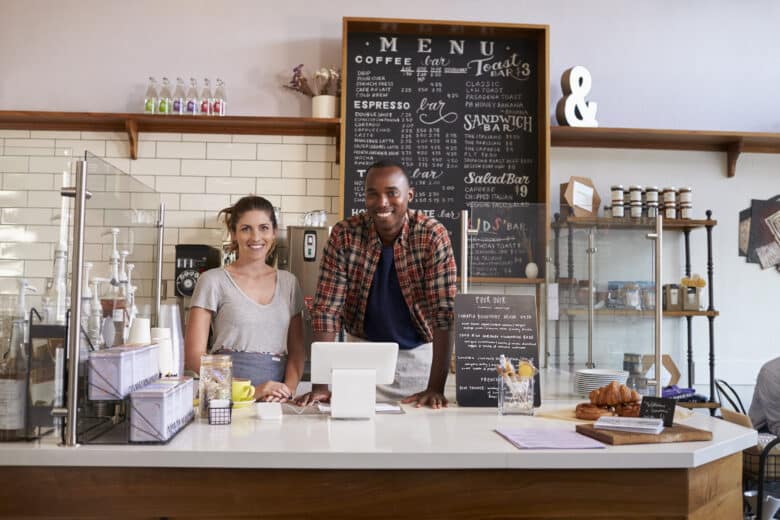 mixed race couple waiting behind counter at a coffee shop